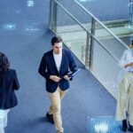 Digital technology concept with multinational people meeting in lobby.